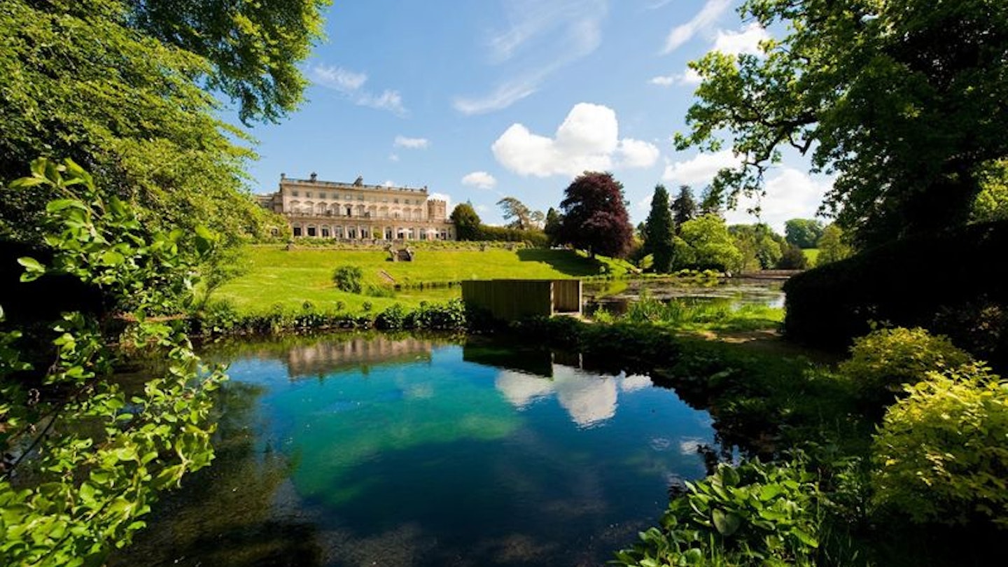 A view of Cowley Manor Experimental across a lake