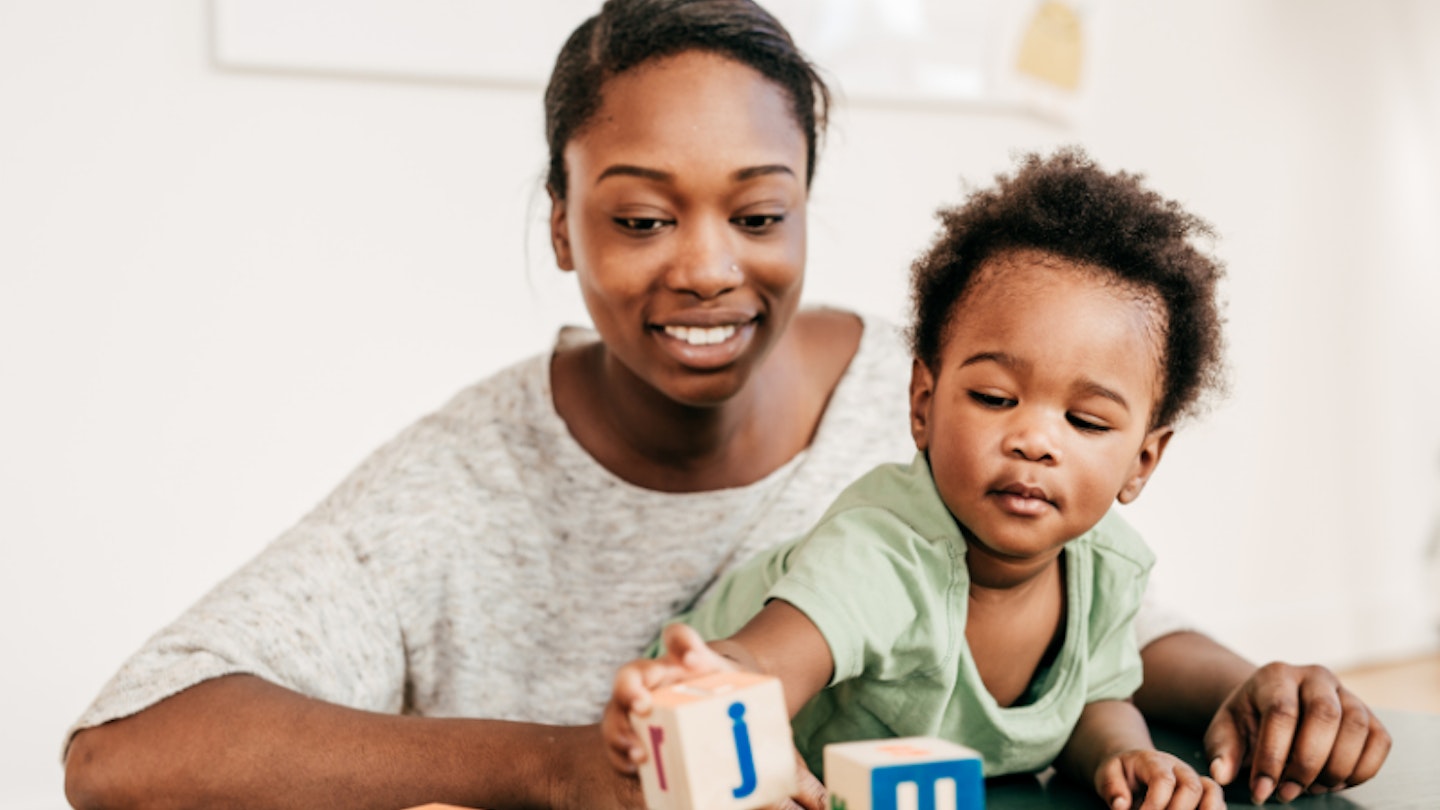 Mother and baby playing with building toys