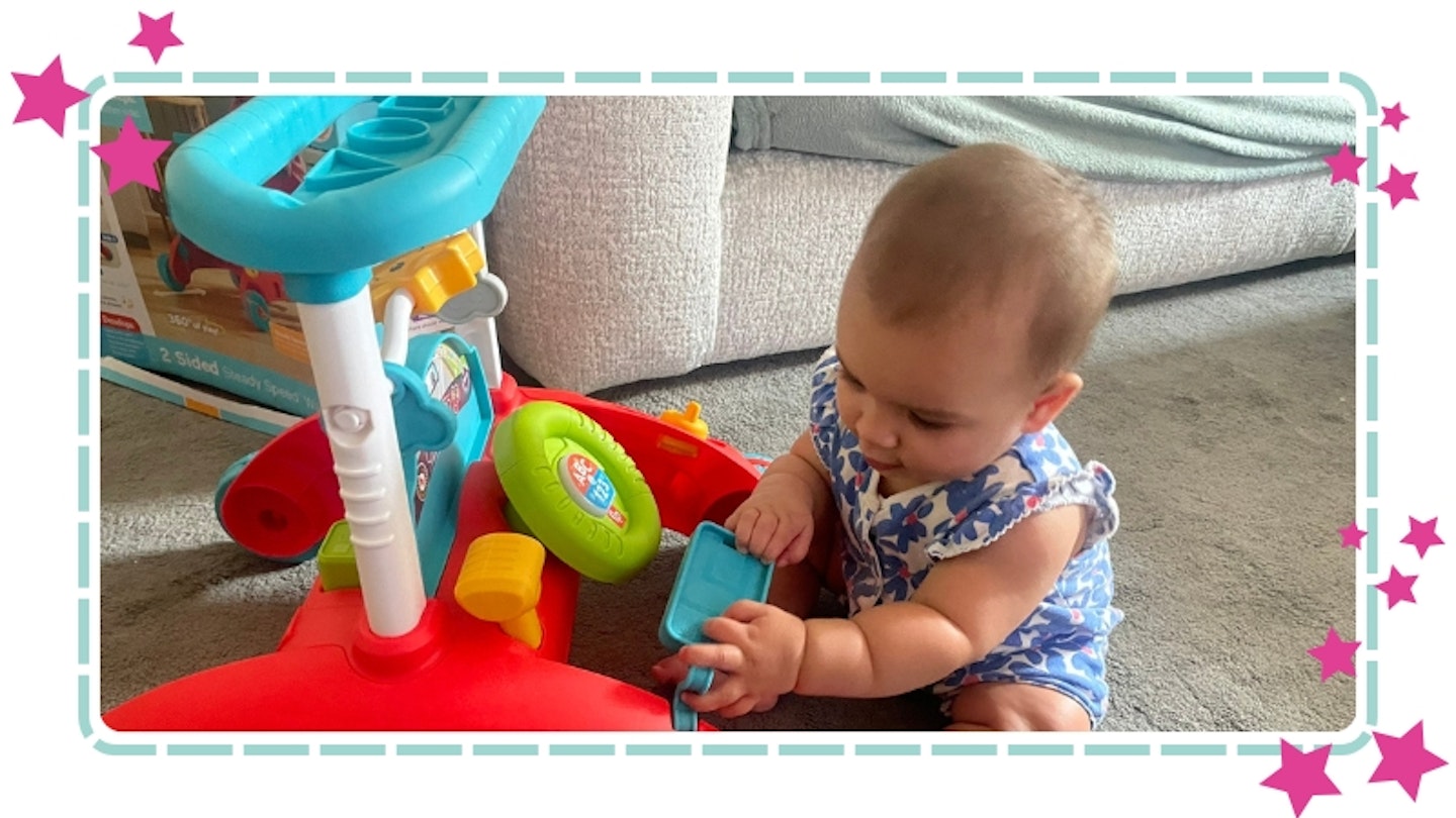 baby playing with Fisher-Price 2-sided steady speed walker