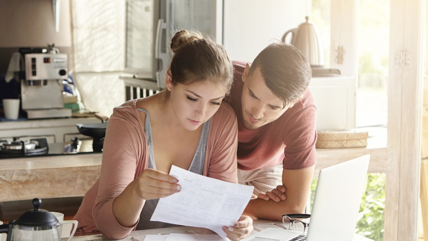 A pregnant couple looking at their MAT B1 form