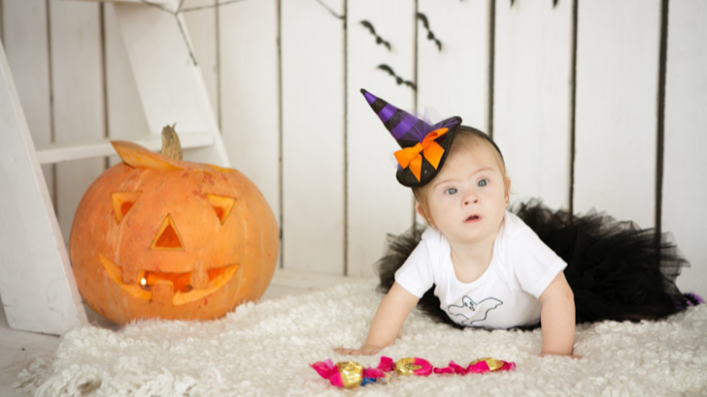 Baby dressed as witch for Halloween