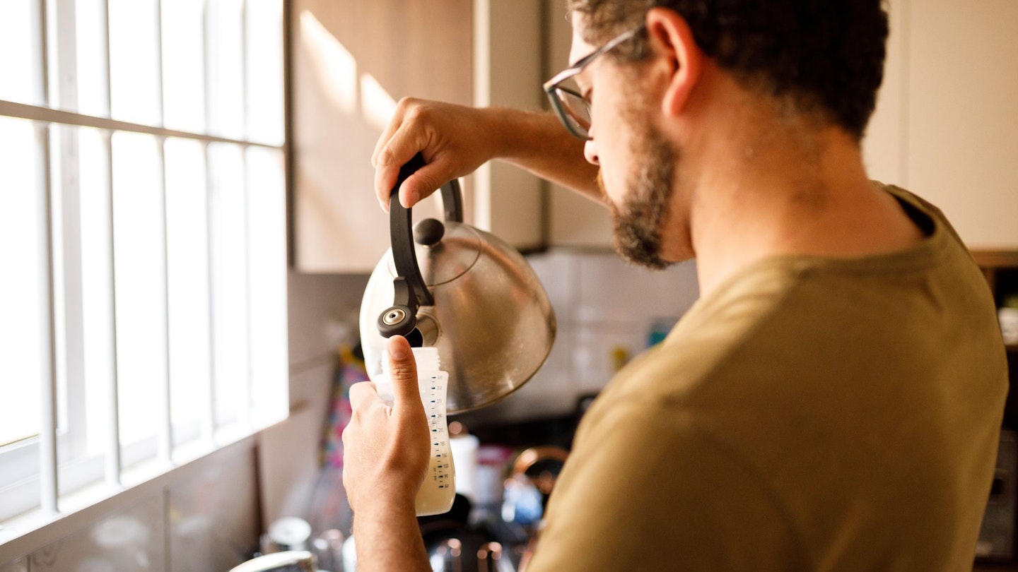 Man preparing baby's bottle