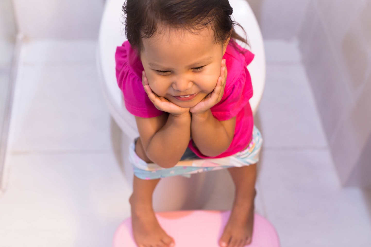 Little girl going to the toilet whilst potty traiining.