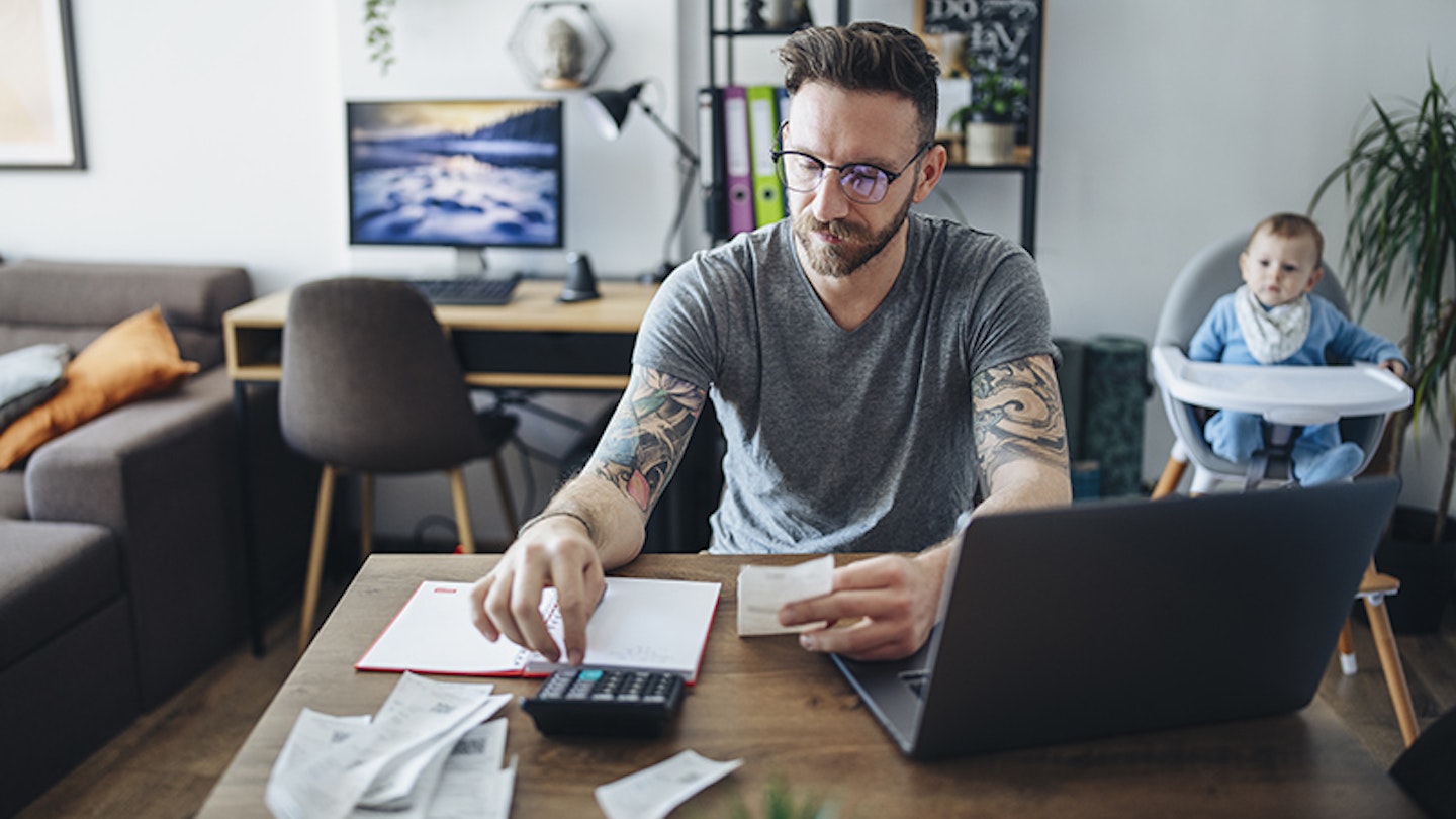 Single father managing monthly expenses at home.
