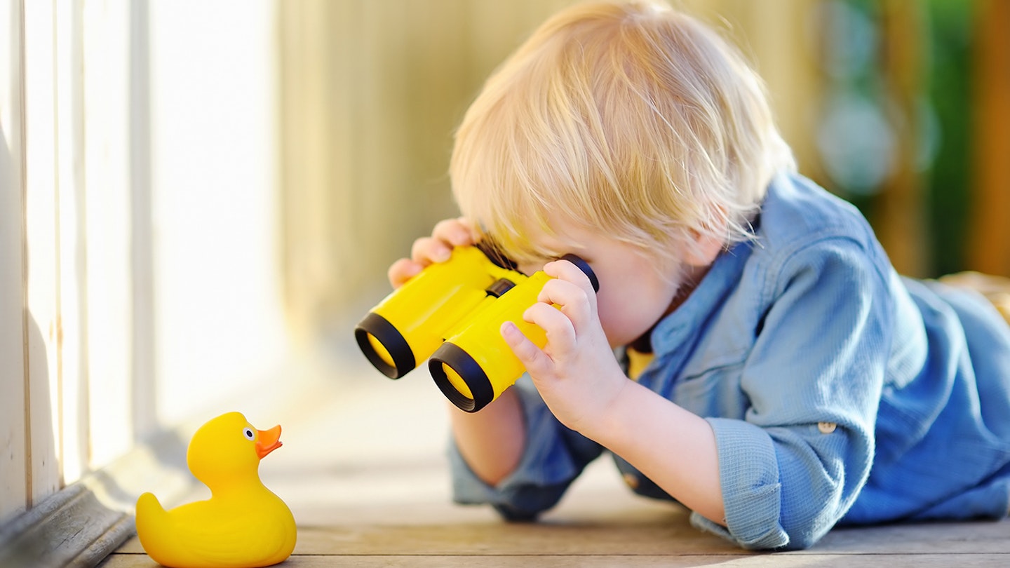 toddler playing with binoculars, finding objects in house