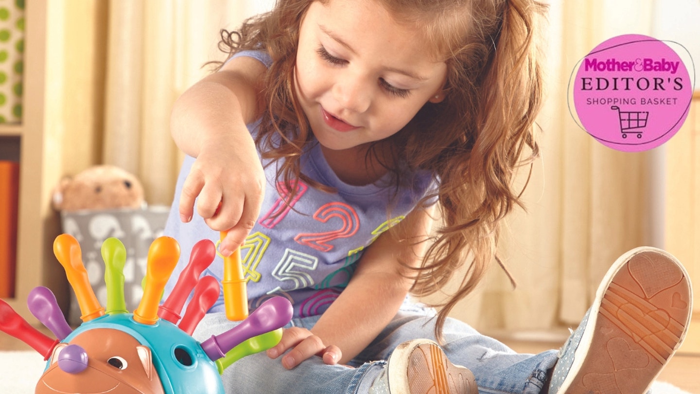 Toddler plays with Spike the Hedgehog toy
