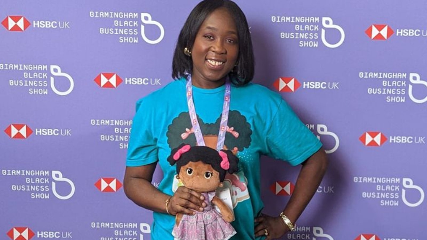 Stephanie Mensah at the Birmingham Black Business Show, holding a Bibinee Doll