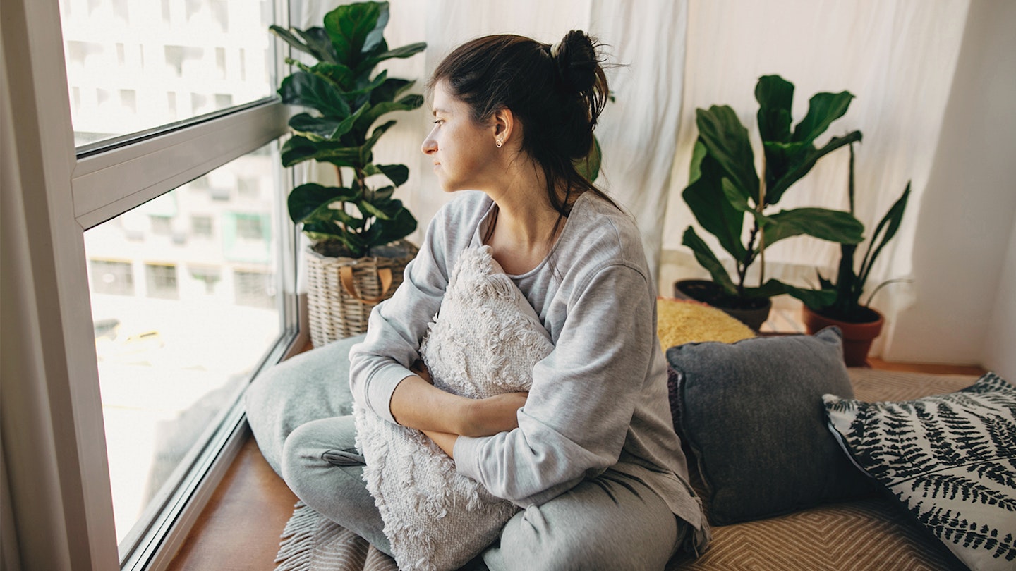 woman looking out window