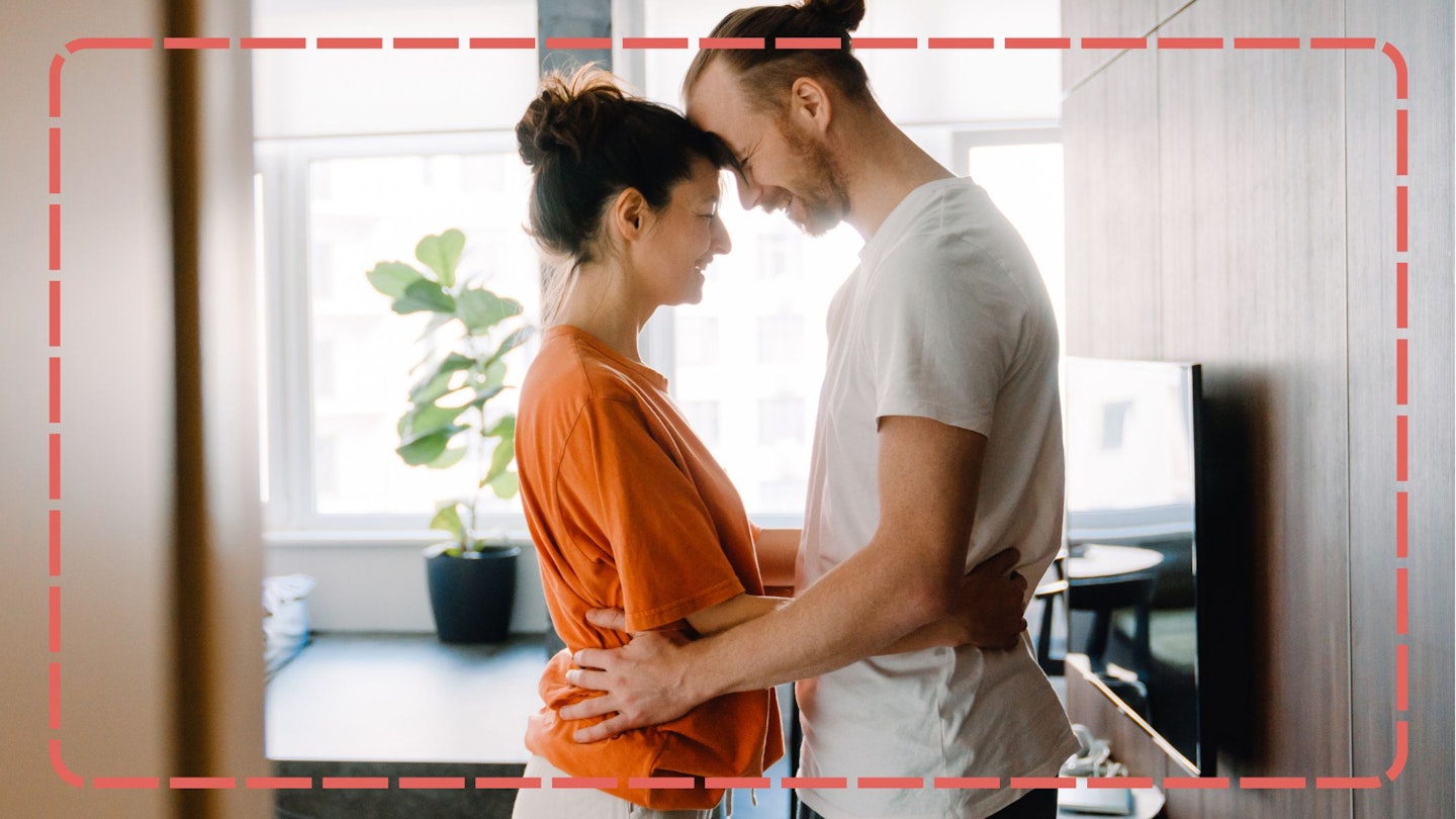 Young White Couple Smiling and Hugging Together in Bedroom at Home